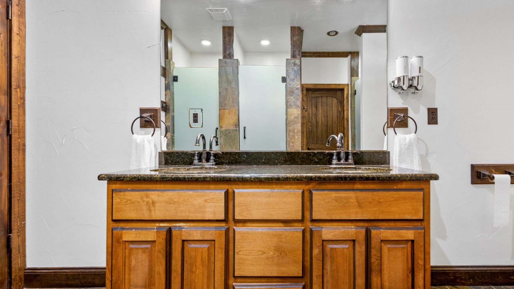 a kitchen with a sink and a mirror